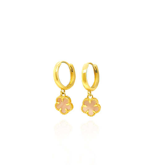 Gold hoop earrings with floral charms on a white background