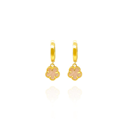 Gold hoop earrings with pink flower charms on a white background