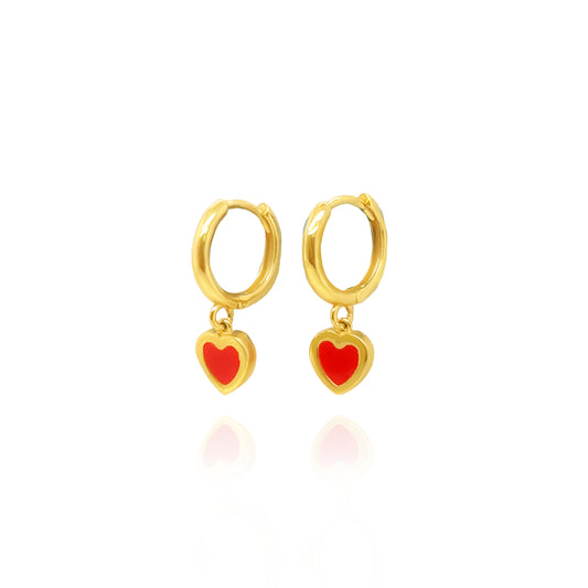 Gold hoop earrings with red heart charms on a white background