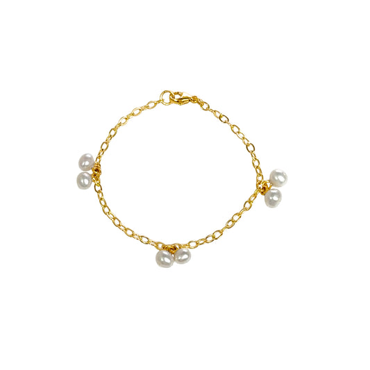 Gold bracelet with pearls on a white background