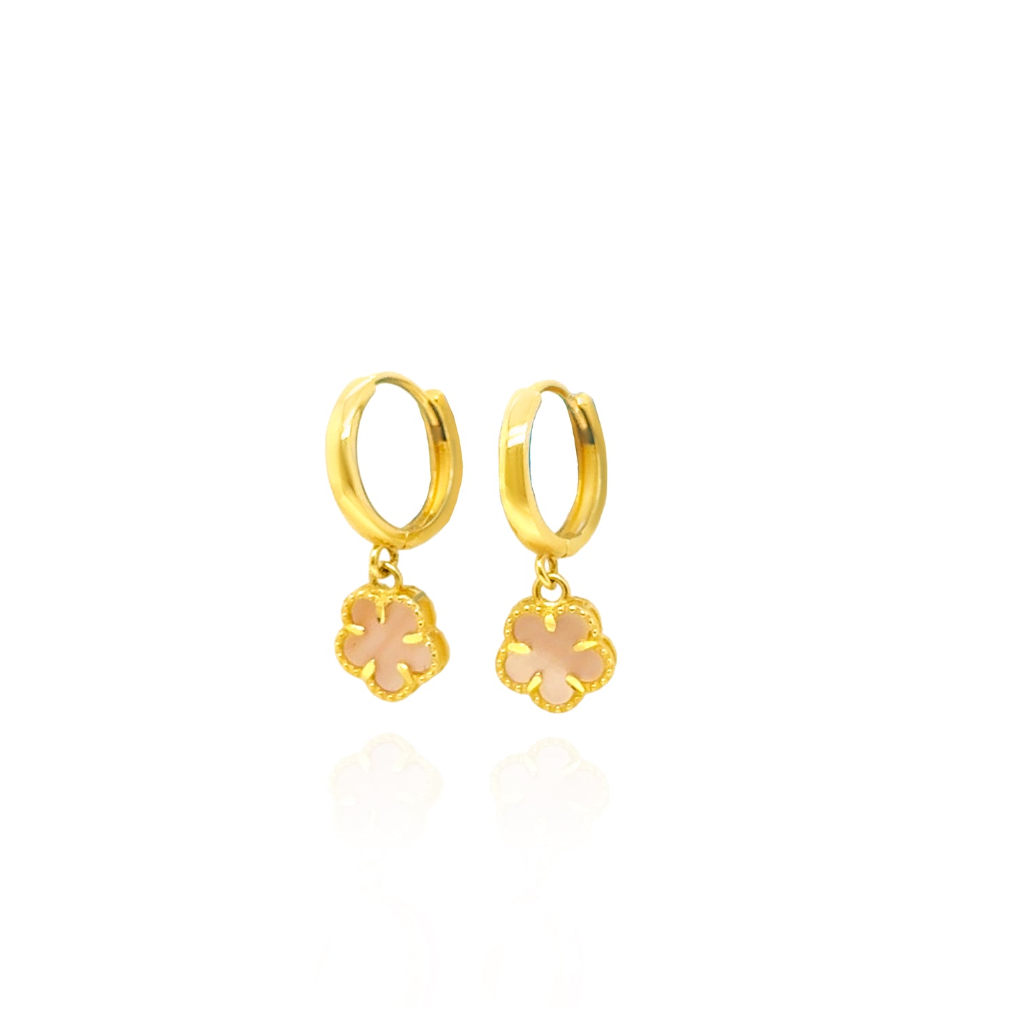 Gold hoop earrings with floral charms on a white background