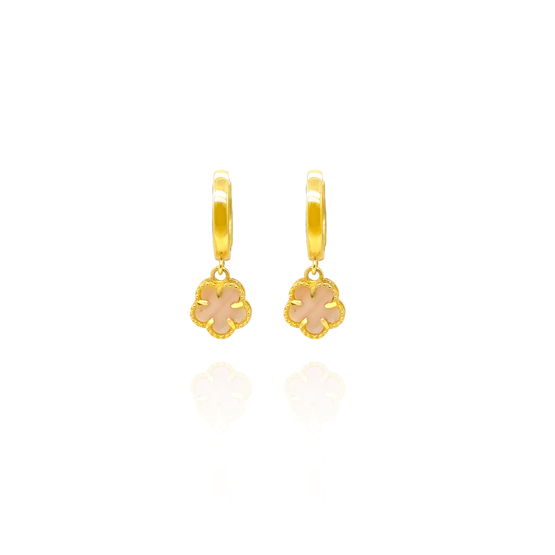 Gold hoop earrings with pink flower charms on a white background