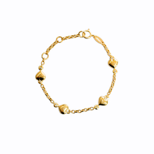 Solid gold baby bracelet with four puffy heart charms