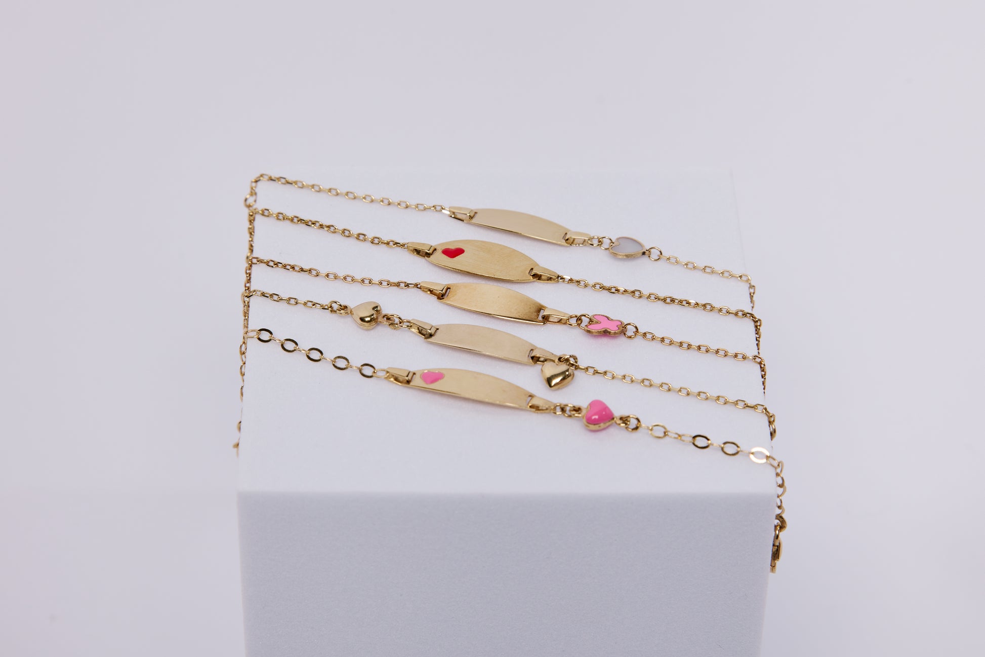 Engravable 14k gold baby ID bracelet name bar with red heart enamel detail
